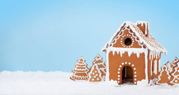 istock Christmas greeting card with gingerbread house 1352655249
