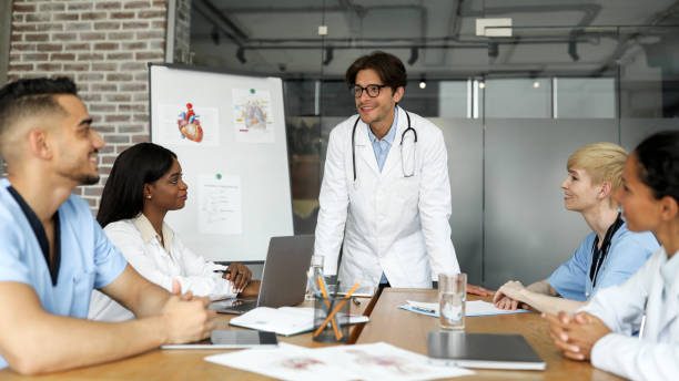 istock Smiling man chief physician making presentation for international colleagues 1352656888