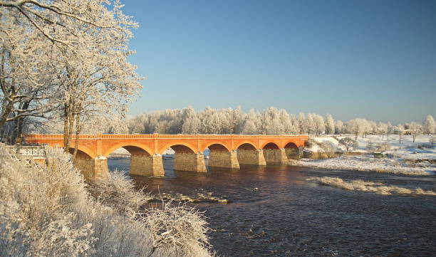 istock Long brick bridge over Venta river in winter day, Kuldiga, Latvia 1352656980