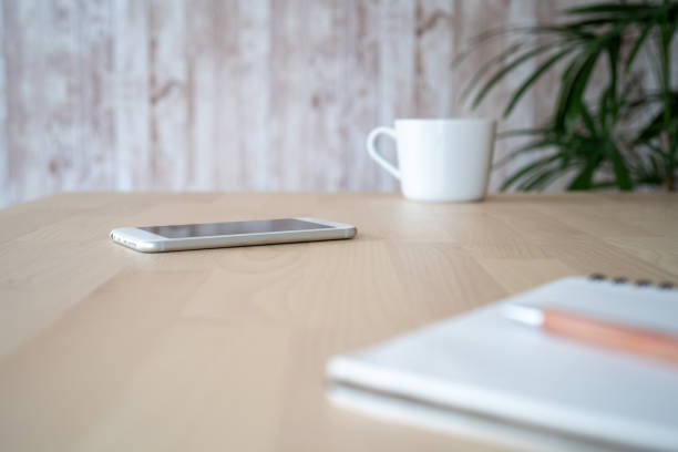 istock A smartphone, notebook, pen, and cup on the table. 1352659753