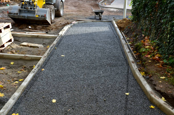 istock Pavement construction, laying concrete curbs in the foundation. construction work excavator. builders are making new street surfaces. the tiles will be laid in gravel. autumn workspace. scoop, wheels 1352660884