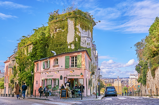 Paris, France - September 29, 2021: People in front of the Bistrot La Maison Rose on Rue des Saules on Montmartre in Paris.