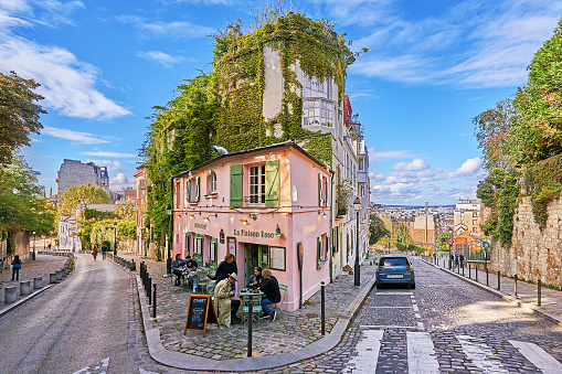 Paris, France - September 29, 2021: People in front of the Bistrot La Maison Rose on Rue des Saules on Montmartre in Paris.