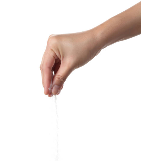 istock Hand holding sea salt isolated on white background 1352664842