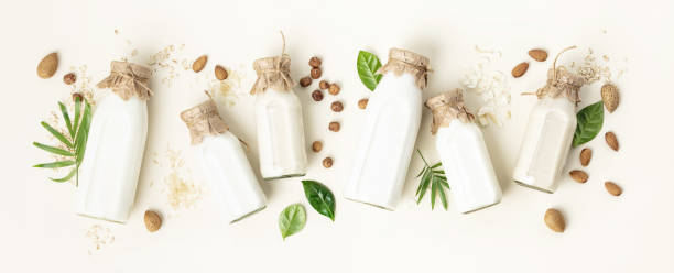 istock on dairy plant based milk in bottles and ingredients on light background. Alternative lactose free milk substitute, flat lay 1352665191