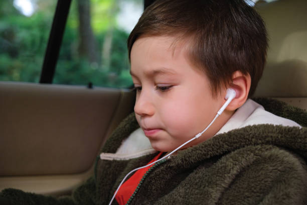 istock 4-5 years old child using digital tablet at car 1352666073