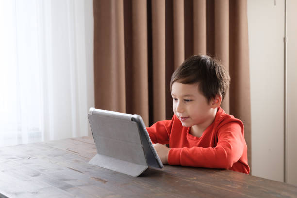 istock 4-5 years old child using digital tablet at home 1352666113