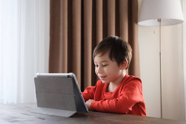 istock 4-5 years old child using digital tablet at home 1352666167
