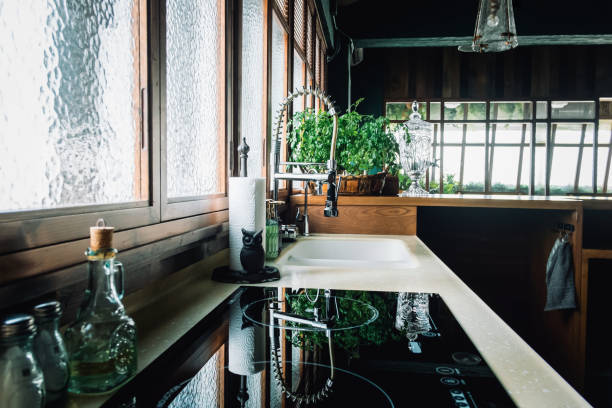 Cozy interior of modern open kitchen, with kitchen accessories and cooking utensils. Sunlight coming through window