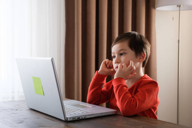 istock 4-5 years old child using laptop at home 1352666314