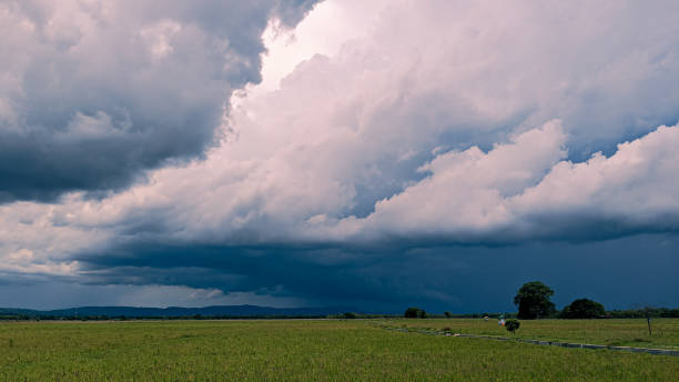 istock dramatic dark black clouds and storm before rainy 1352669196
