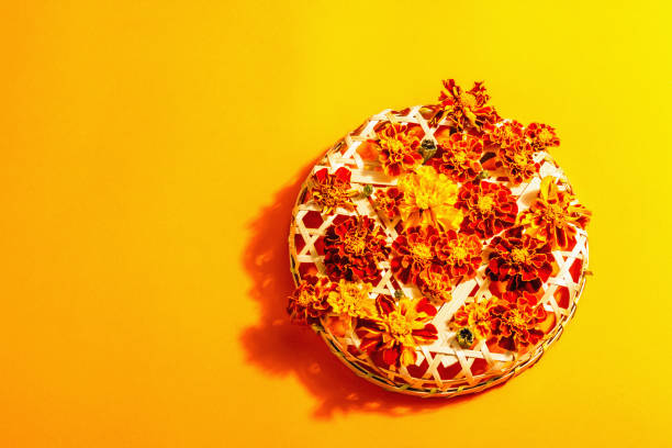 istock Autumn composition from assorted marigold flowers, isolated on orange background 1352669285
