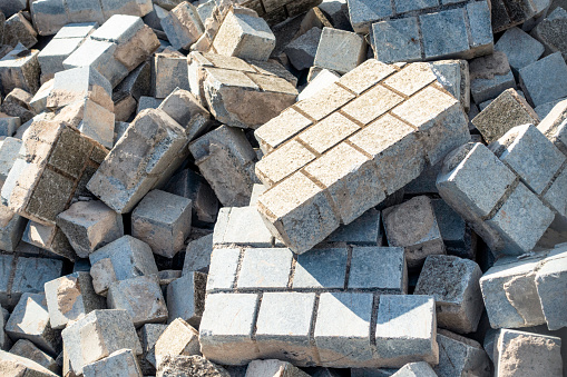 A close up of broken building materials on a construction site, following a concrete wall being smashed during demolition works.