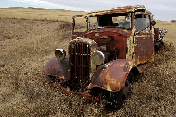 An old farm pick up truck now decorates the field where it was abandoned.