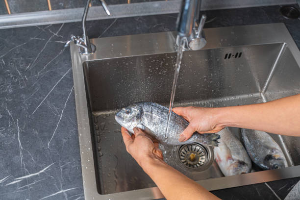 istock Dorado fish washing under running water 1352674632