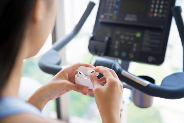 sport woman using wireless headphone in gym sport clup stock photo