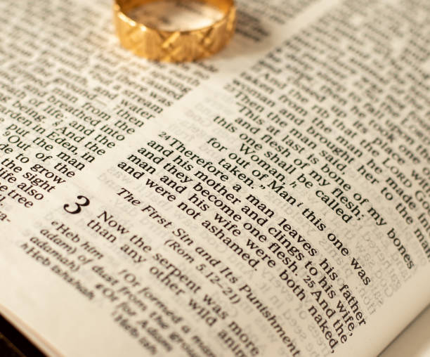 istock Open Holy Bible with a gold ring on a book of Genesis 1352680561