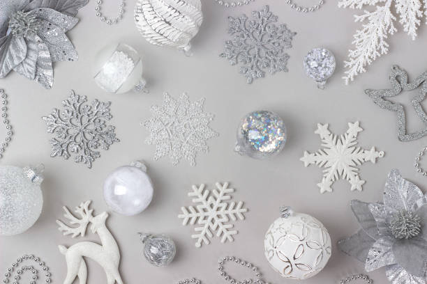 istock Holiday pattern made silver and white shiny christmas decorations on grey background. Happy Christmas, Xmas and New Year concept. Top view, Flat lay 1352685345