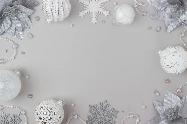 istock Holiday frame made silver and white shiny christmas decorations on grey background. Happy Christmas, Xmas and New Year concept. Top view, Flat lay, Copy space 1352685425