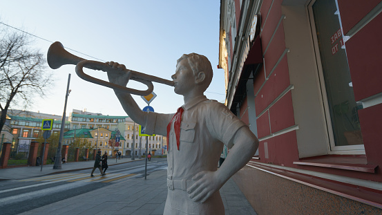 Moscow, Russia - October 31, 2021: Pierogi  1 cafe entrance. Russian home cuisine restaurant chain. Statue of  member of Vladimir Lenin All-Union Pioneer Organization. Verkhnyaya Radishchevskaya str.
