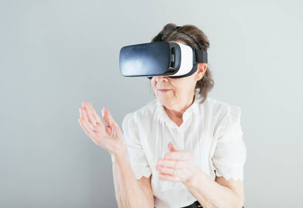 istock Senior woman with VR headset 1352686081