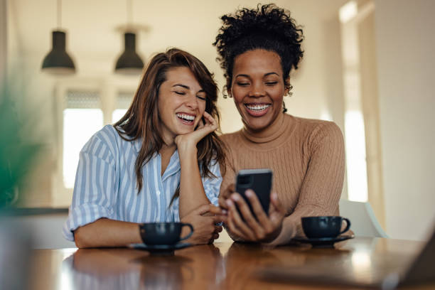 istock Joyful diverse partners, using the phone to go online 1352686778