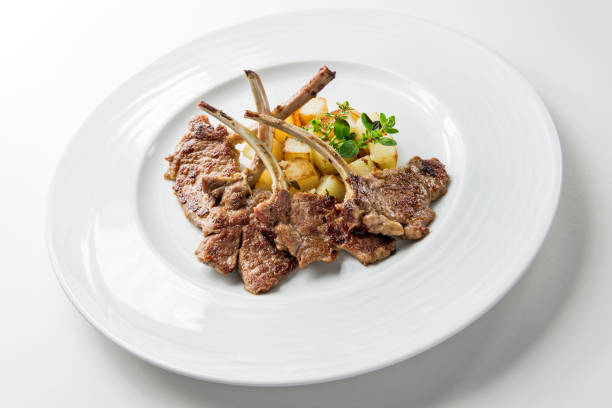 istock Plate with lamb ribs and potatoes 1352686789