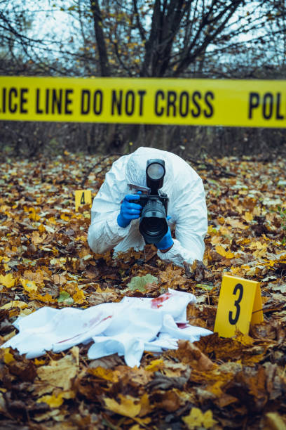 Forensic scientist working at crime scene Senior forensic scientist doing photographs at crime scene dna test flash stock pictures, royalty-free photos & images