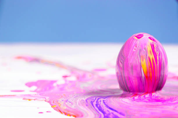 Painting Easter eggs, Preparation for spring holiday, Liquid marble texture, Marble ink colorful, Fluid art Abstract Trend, Red and Yellow Easter eggs.
