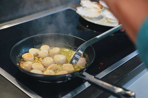 istock Cooking Scallops in a Cooking Pan 1352695563