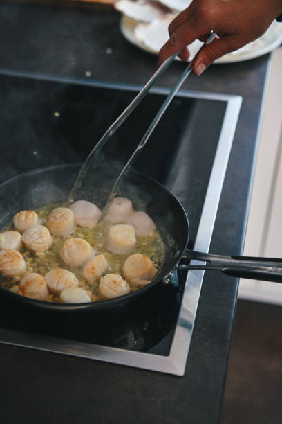 istock Cooking Scallops in a Cooking Pan 1352695567