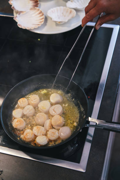 istock Cooking Scallops in a Cooking Pan 1352695568