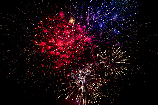 Red, white and blue fireworks in the night sky