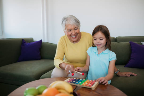 istock Senior woman playing with child 1352698331