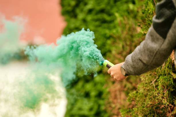 istock Green colored smoke grenade in hand 1352698958