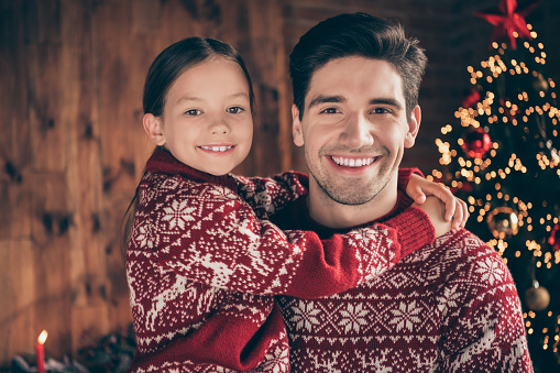 Photo of happy young positive daughter father good mood smile tree xmas tree indoors inside house home flat.