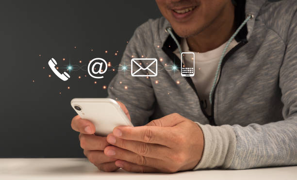 Contact us or call our customer service hotline. Businessman Using a laptop and interacting with virtual screen contact icons ( email, address, live chat, internet )