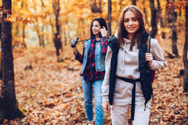 istock Two female friends hiking together 1352701392