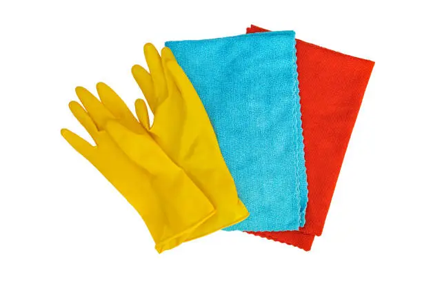 rubber yellow gloves and rags for cleaning on a white background. Isolated object.