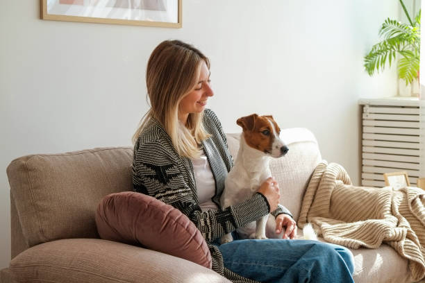 istock Young woman with a pup at home 1352704136