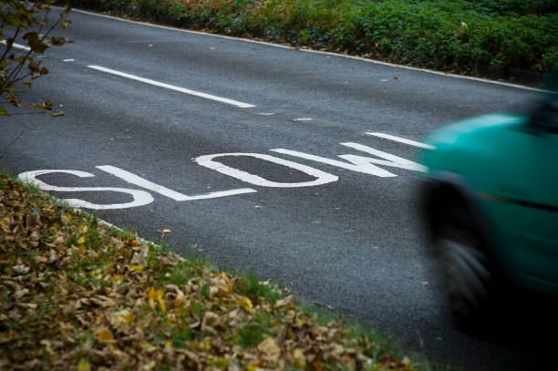 Slow warning sign painted on a country road, Leicestershire, England, UK.