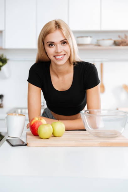 istock Vertical image of woman in kitchen 1352707880
