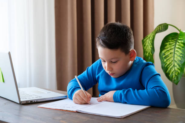istock 8 years old cute child doing homework at home 1352709529