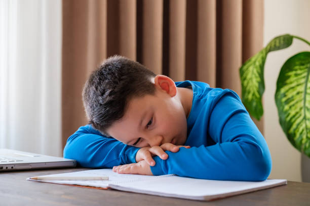 istock 8 years old cute child doing homework at home 1352709560