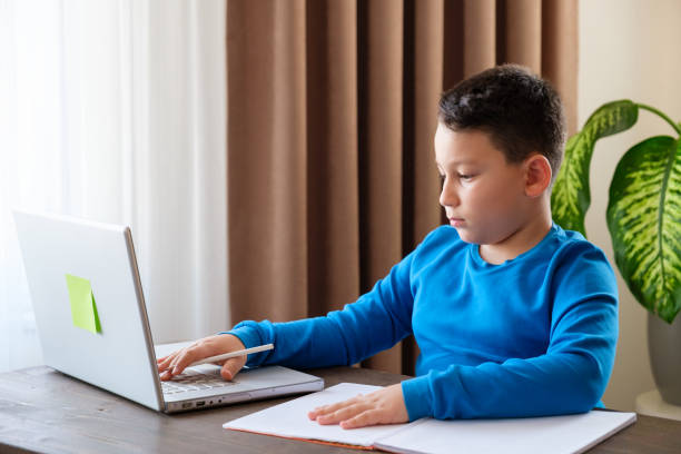 istock 8 years old cute child doing homework at home 1352709577