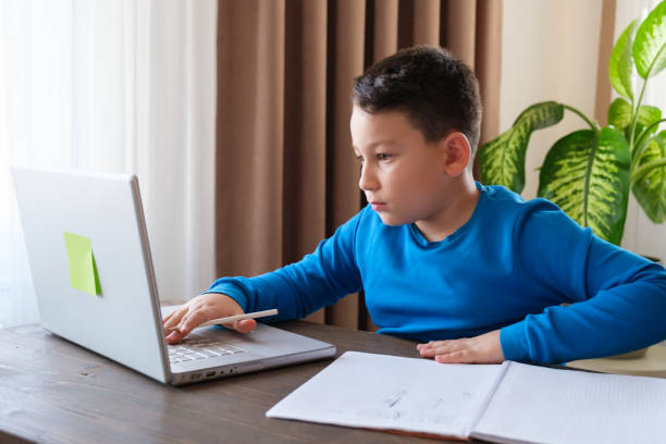 istock 8 years old cute child doing homework at home 1352710105