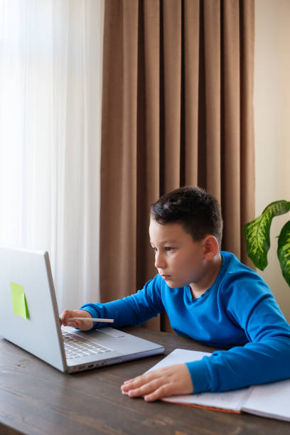 istock 8 years old cute child doing homework at home 1352710107