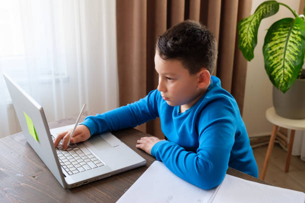 istock 8 years old cute child doing homework at home 1352710119