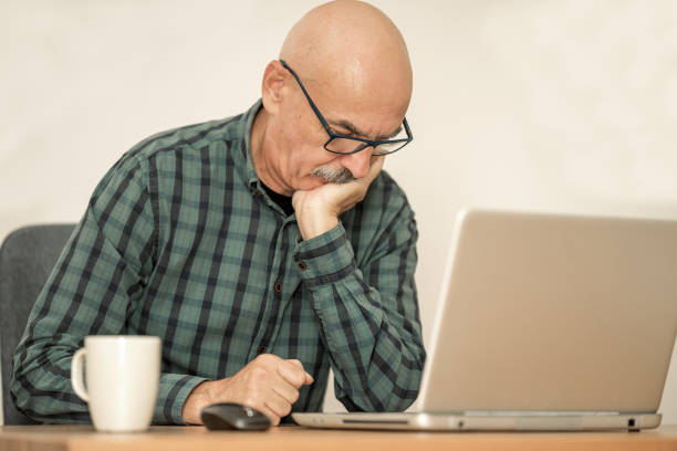 istock Senior Man Working with Laptop at Home 1352710447