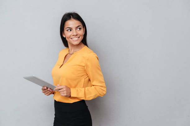 istock Side view of business woman holding tablet computer 1352710735